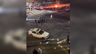 Driver is seen discarding a Stolen Infiniti into a fire pit at a sideshow in Los Angeles, California