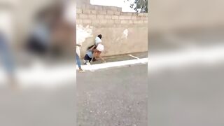 A woman who went viral for beating a high school student in the street was arrested.
