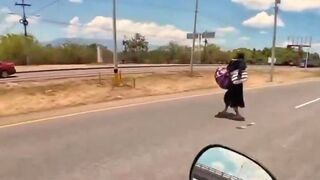 Woman crossing the road hit by a truck caught on a biker's GoPro cam