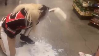 Los Angeles, California.— Woman puts milk on her face after she was Maced by security during an altercation at Food 4 Less
