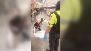 Los Angeles, California.— Woman puts milk on her face after she was Maced by security during an altercation at Food 4 Less