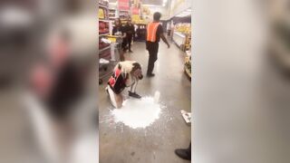 Los Angeles, California.— Woman puts milk on her face after she was Maced by security during an altercation at Food 4 Less