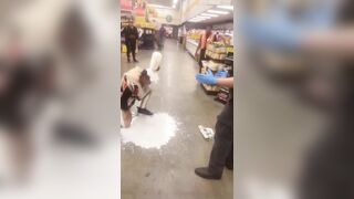 Los Angeles, California.— Woman puts milk on her face after she was Maced by security during an altercation at Food 4 Less