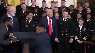 Navy Team presents Trump with Football.