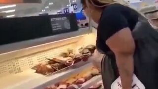 How Sad: Vegan activists pay homage to the fallen at the meat counter.