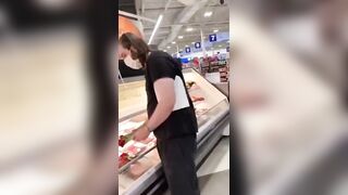 How Sad: Vegan activists pay homage to the fallen at the meat counter.