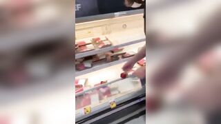 How Sad: Vegan activists pay homage to the fallen at the meat counter.