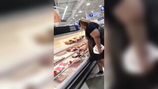 How Sad: Vegan activists pay homage to the fallen at the meat counter.