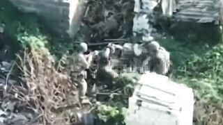 A drone filmed a captured Ukrainian soldier attempting to take weapons from Russian soldiers