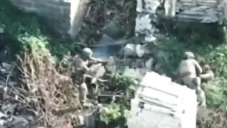 A drone filmed a captured Ukrainian soldier attempting to take weapons from Russian soldiers