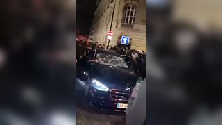 Paris, Beautiful Paris. Car tries to make it through Protestors