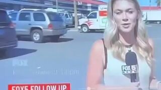 A black drug addict runs up touching her begging for $1 on live TV.