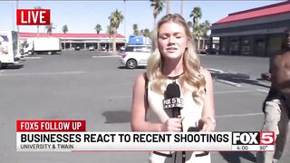 A black drug addict runs up touching her begging for $1 on live TV.