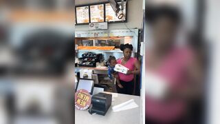 Woman holding her Baby helps Herself to the Chicken. Pay? nah