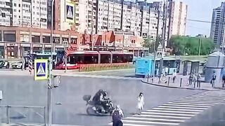 Woman on the Phone ends up in Wheels of a Bike