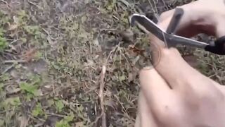 Russian soldiers cutting the fiber optic cable of a Ukrainian drone.