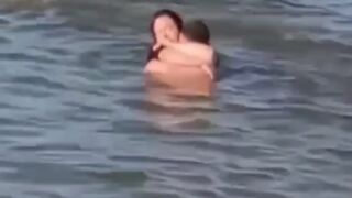 Lovebirds engage in debauchery in the water right next to swimming families