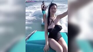 Gravity almost Wins, btw did you notice the Guy on the Water Board behind Her?