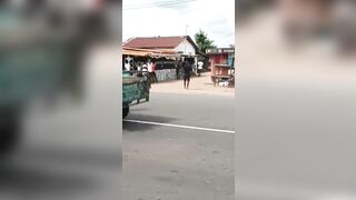 Pay Arrention: Motorcycle Taxi Funeral Celebration sends one Man down the Street (Slow Motion)