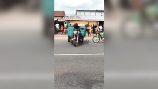 Pay Arrention: Motorcycle Taxi Funeral Celebration sends one Man down the Street (Slow Motion)