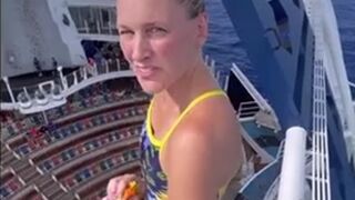 Dare devil jumps from a high spot in to a swimming pool !