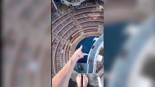 Dare devil jumps from a high spot in to a swimming pool !