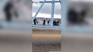 In the US, a cop beat up liberals who blocked a road protesting the actions of the Immigration Service.