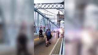 In the US, a cop beat up liberals who blocked a road protesting the actions of the Immigration Service.