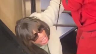 Woman grew tired of a man in a wig holding up the train