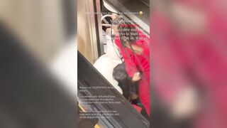 Woman grew tired of a man in a wig holding up the train