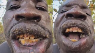 African man eating a fully cooked dog shows the variety of Human Behavior
