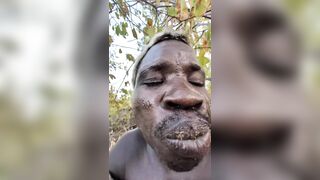 African man eating a fully cooked dog shows the variety of Human Behavior