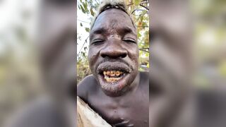 African man eating a fully cooked dog shows the variety of Human Behavior