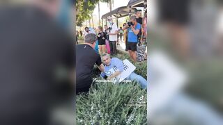 Man holding "You proved Charlie right" sign ATTACKED and pushed to ground by anti-ICE