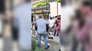 Man holding "You proved Charlie right" sign ATTACKED and pushed to ground by anti-ICE