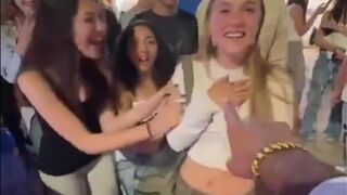 He extends his hand to four girls to see who will give him their hand and this happens.