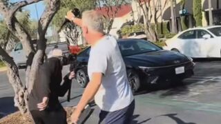 Man throws wine on multiple masked men after they started randomly filming people