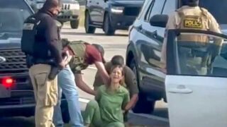 Feds forcibly detain a woman in medical scrubs as she screams she's a US citizen