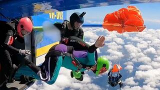 A skydiver's parachute gets caught on plane's tail