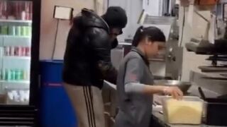 A Pizza Pizza employee was seen talking on his cell phone while making dough